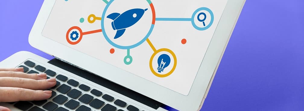 Close-up of hands on a keyboard next to an illustrative digital launch icon.
