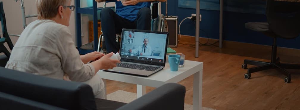 Woman consulting a virtual healthcare provider online from home during a remote checkup.